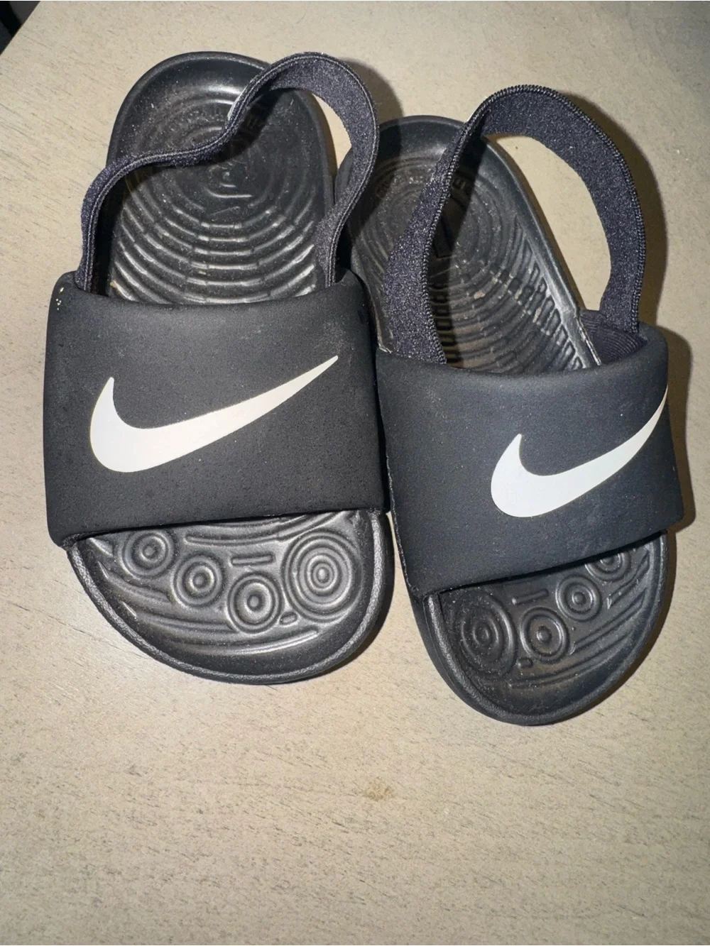Nike Kids Black Slides with White Swoosh and Back Heel Strap